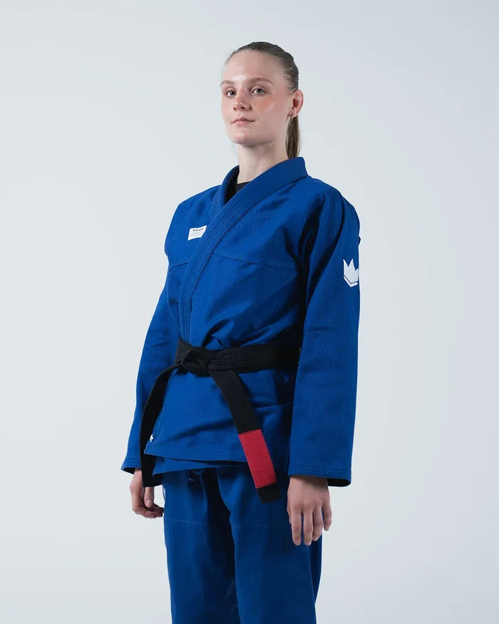 Kingz Kore V2 Women's BJJ Gi Blue - 3/4 Angled Upper Body Front View Female Athlete Black Belt Red Bar Crown Logo Sleeve