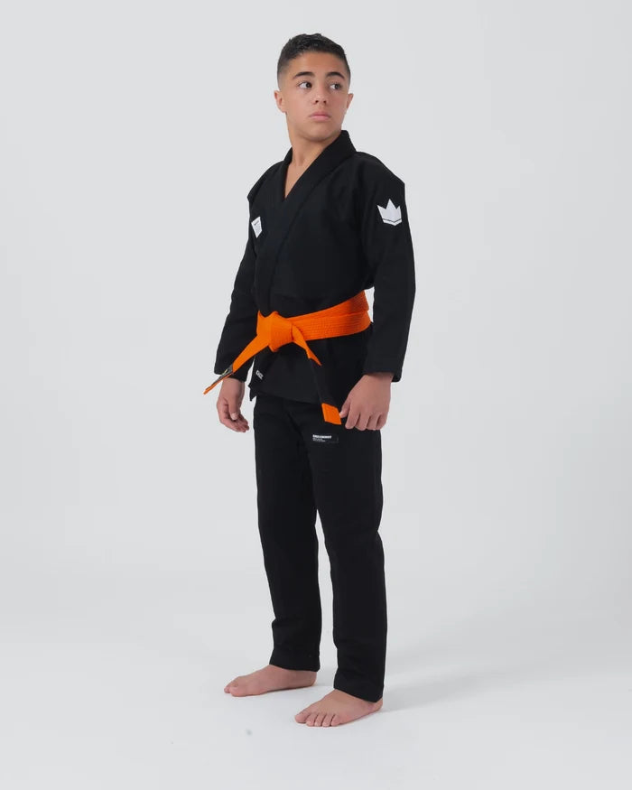 Kingz Kore V2 Youth BJJ Gi Black - Full Body Angled Front View Teen Athlete Orange Belt Crown Logo Sleeve Youth Kids