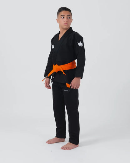 Kingz Kore V2 Youth BJJ Gi Black - Full Body Angled Front View Teen Athlete Orange Belt Crown Logo Sleeve Youth Kids