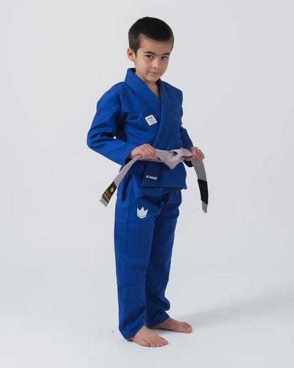 Kingz Kore V2 Youth BJJ Gi Blue - Full Body Front View Youth Athlete Gray Belt KINGZ Logo Tying Belt Pose Youth Kids