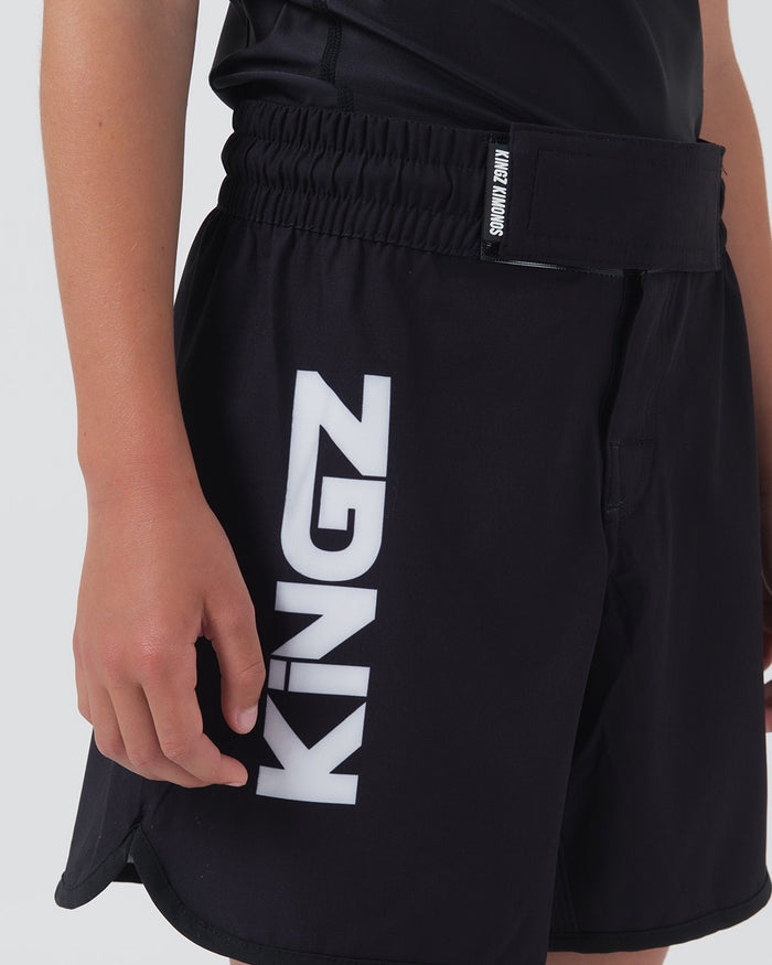 Kingz Kore V2 Youth Shorts Black - Full Body Left Side Profile Alternate Stance Teen Boy Athlete KINGZ Bold White Text Left Leg Side Split Kids Grappling Shorts No-Gi BJJ Kore Collection [color:Black]