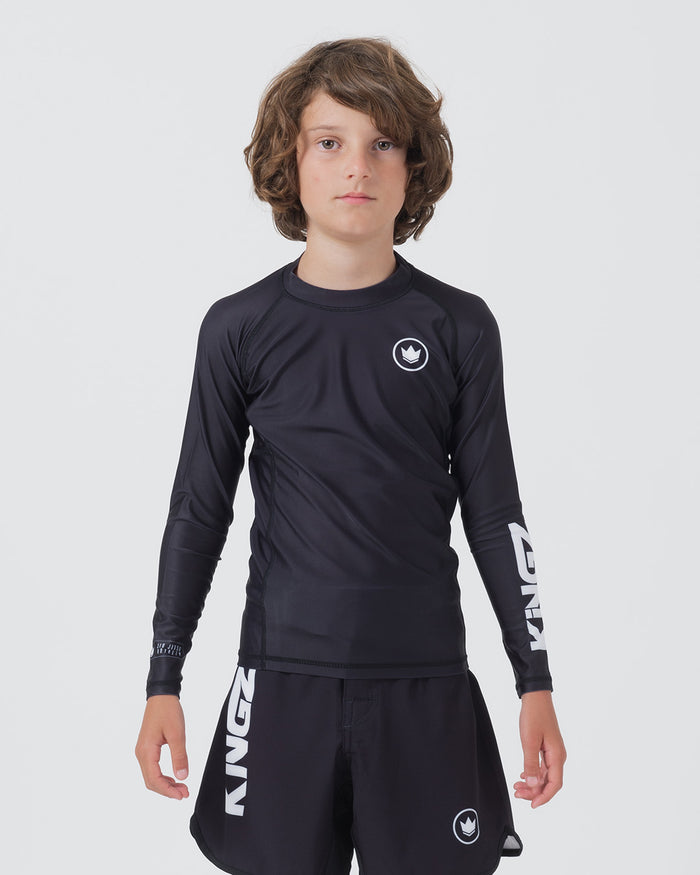 Kingz Kore V2 Youth L/S Rashguard Navy Black - Full Body Front View Teen Boy Athlete Long Sleeve Navy Blue Minimal Design White Crown Logo Circle Chest KINGZ White Sleeve Text Matching Navy Shorts Kids BJJ Training [color:Black]