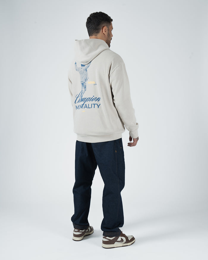 Tan BJJ Champion hoodie rear view on adult male model highlighting blue athlete illustration and script [color:French Oak]