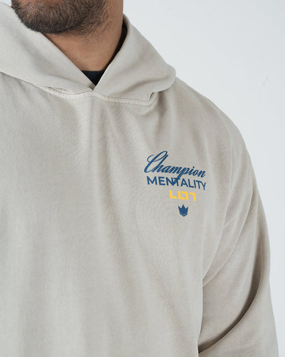 Tan BJJ Champion hoodie back detail view on adult male model showing crisp Champion Mentality print and hood [color:French Oak]