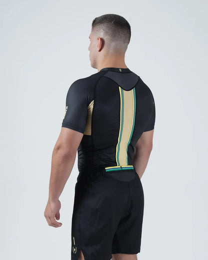 Kingz Player Special Limited Edition Rashguard Black Gold Green - Full Body Straight Back View Male Athlete Short Sleeve Lotus JPS Colors Gold Green Center Back Stripe Crown Logo [color:Black]