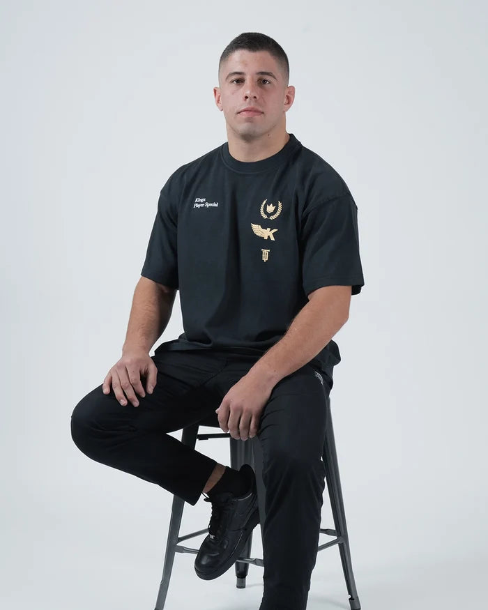 Kingz Player Special Tee - Seated Lifestyle Front - Gold Chest Graphics Editorial BJJ Limited Edition Tee Black [color:Black]