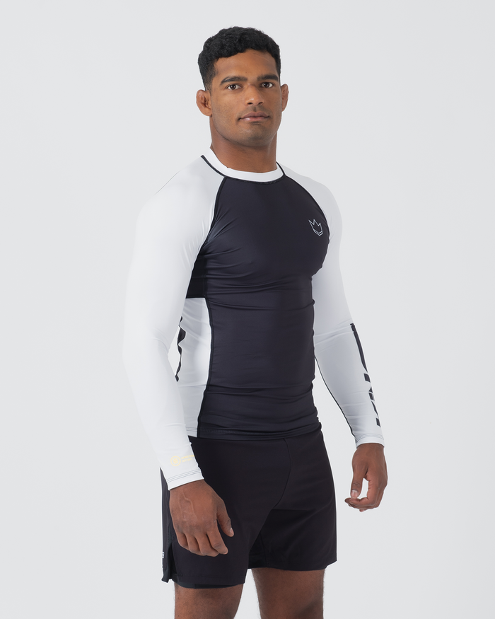 Kingz Ranked Performance V2 L/S Rashguard Navy White - Full Body Front Angled View Male Athlete Long Sleeve Navy Body White Sleeves Yellow Gold IBJJF Rank Cuff Crown Logo Chest Navy Shorts Compression Fit BJJ Ranked Guard [color:White]