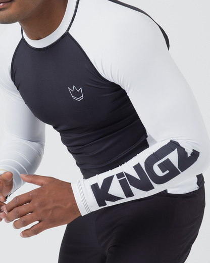 Kingz Ranked Performance V2 L/S Rashguard Navy White - Upper Body Action Pose Right Sleeve Detail KINGZ Large Bold Navy Text White Sleeve Three Stripe Cuff Crown Logo Navy Chest White Side Panel BJJ Training [color:White]