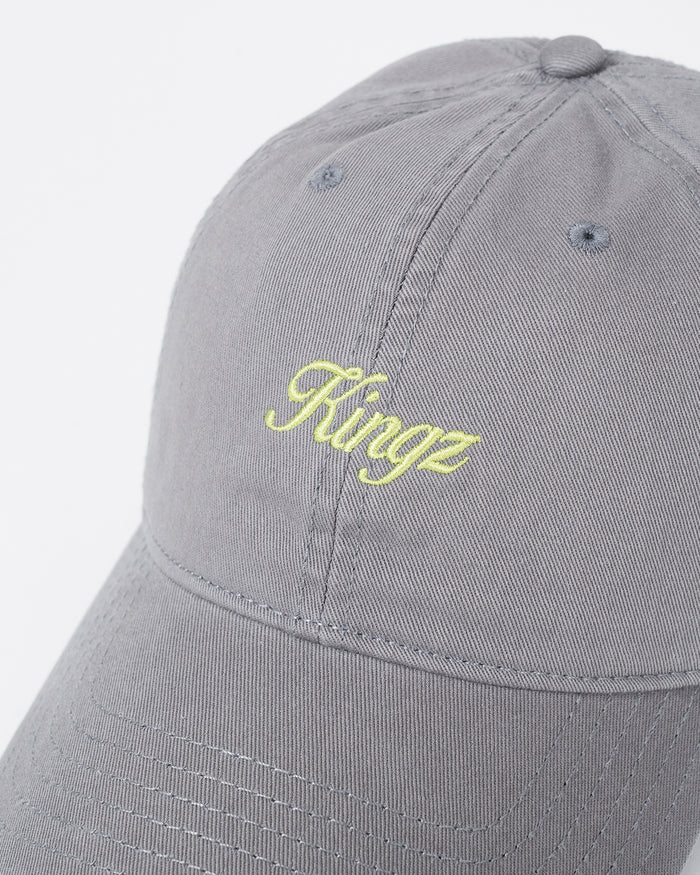 Kingz Script Dad Hat Grey - Close-Up Detail View Embroidered Yellow Kingz Script Logo Centered Grey Cotton Fabric Curved Brim Ventilation Eyelets Casual Fit BJJ Training Hat [color:Grey]
