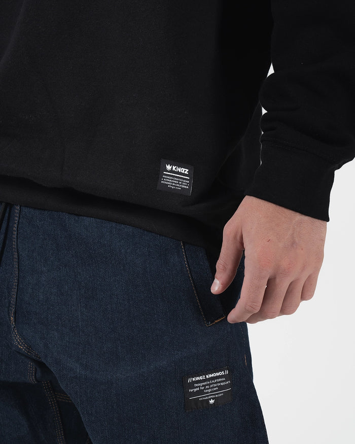 Kingz Script Quarter Zip Sweater Black - Close-Up Detail View Black Fabric Kingz Logo Tag Bottom Hem Casual Fit BJJ Training Hoodie [color:Black]