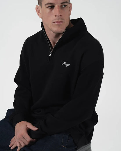 Kingz Script Quarter Zip Sweater Black - Seated Male Model Front View Black Sweater White Kingz Script Logo Left Chest Quarter Zip Design Relaxed Fit Casual BJJ Training Hoodie [color:Black]