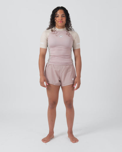 Kingz Terra Women's Rashguard Soil Edition - Full Body Front View Female Athlete Short Sleeve Dusty Rose Mauve Body Cream Beige Raglan Sleeves Crown Logo KINGZ Text Matching Mauve Hybrid Shorts Barefoot Stance Women's BJJ Terra Collection [color:Baby Pink]