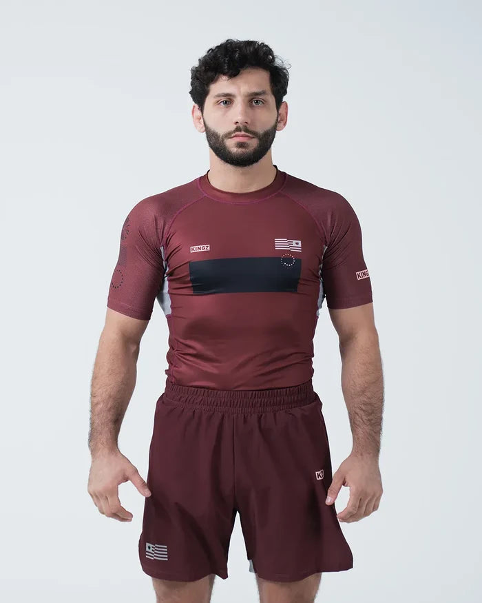 Kingz Trooper Rashguard Maroon - Full Body Front View Male Athlete Short Sleeve KINGZ Logo Black Chest Band Flag Patch Sublimated Graphics [color:Maroon]