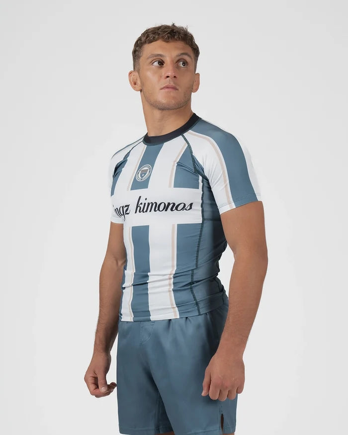 Kingz Vintage Futebol Rashguard Blue White Stripe - Full Body 3/4 Angled Front View Male Athlete Short Sleeve Retro Football Kit KINGZ Crest Badge Cursive Kingz Kimonos Text [color:Green/Vintage]