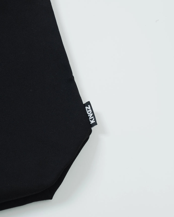 Kingz Kore Eco Bag - Side KINGZ Label Close-Up - Woven Branding on Black Canvas Material BJJ Bag