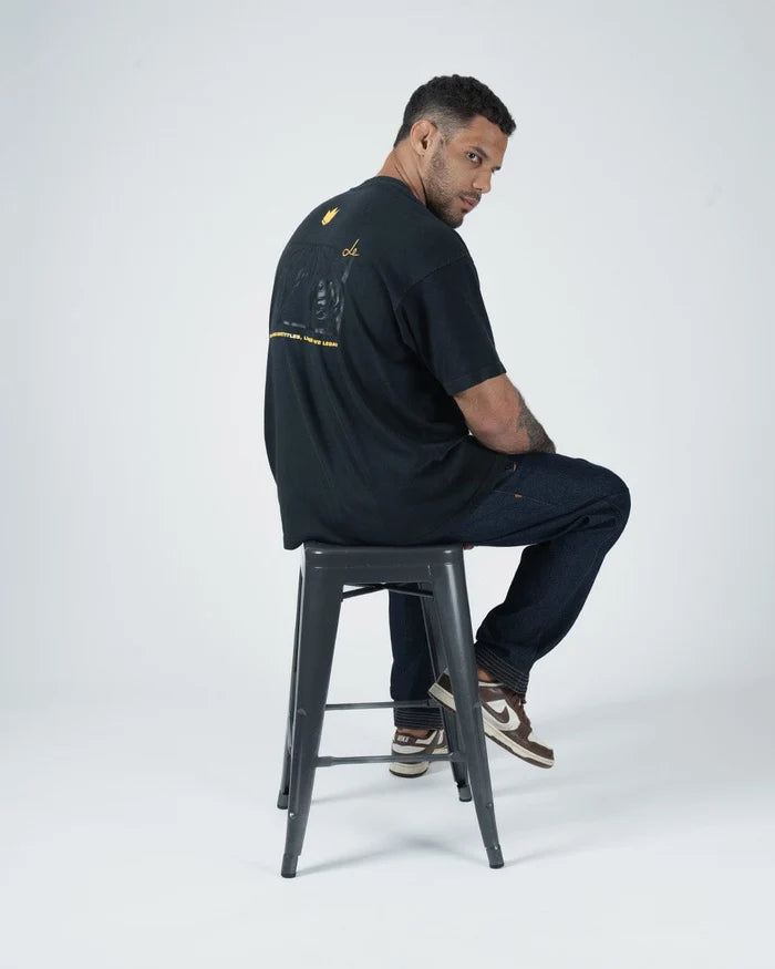 Kingz Leandro Lo Legends Never Die Tiger Tee - Seated Lifestyle Shot - Back Graphic Side View - Black BJJ Tee [color:Black]