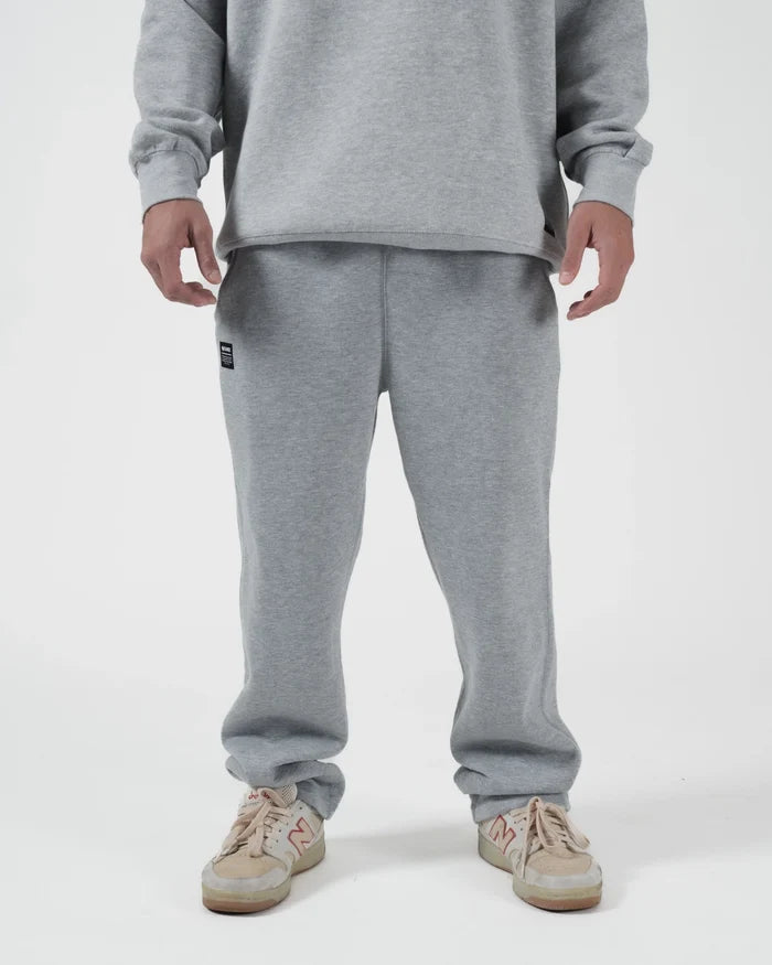 Kingz Loungewear Jogger Grey - Front View Male Athlete Grey Jogger Pants Elastic Waistband Black Kingz Patch Left Thigh Relaxed Fit Casual Wear BJJ Training [color:Black]