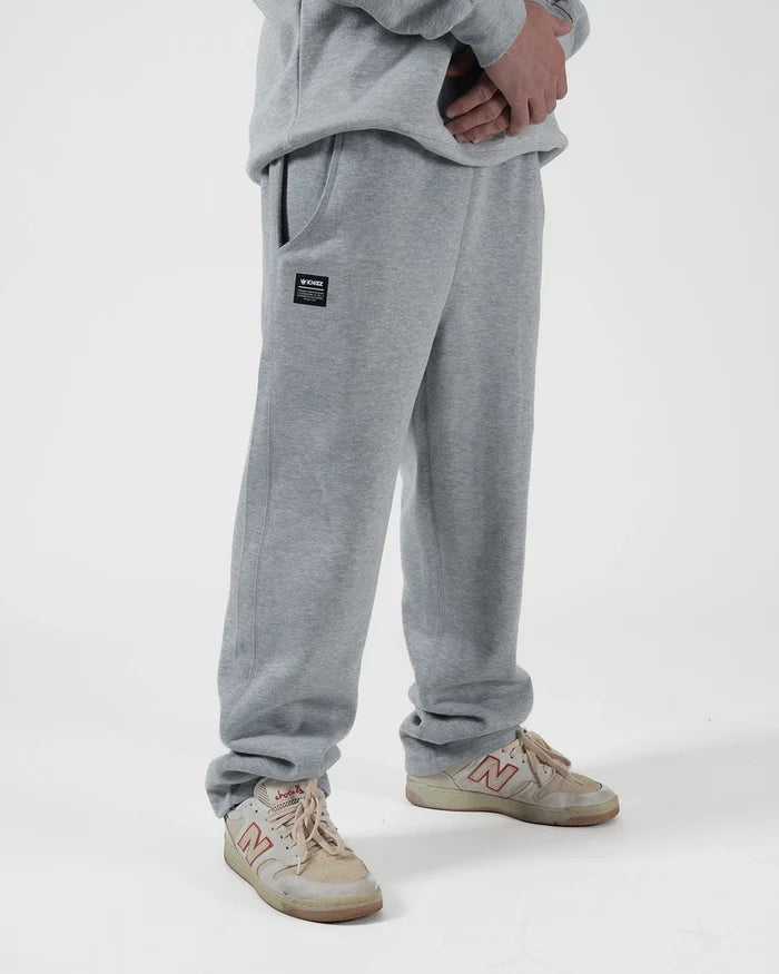 Kingz Loungewear Jogger Grey - Partial Body Front View Male Athlete Grey Joggers Black Kingz Logo Patch Left Pocket Relaxed Fit Elastic Waistband BJJ Training Casual Wear [color:Black]
