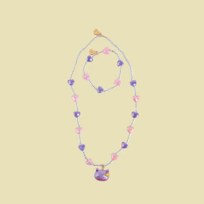 Necklace with heart-shaped beads and a small character pendant on a white background