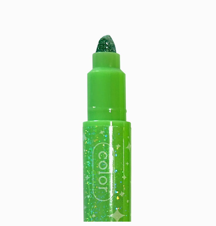 Green glittery lip crayon with 'color' branding on a white background
