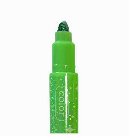 Green glittery lip crayon with 'color' branding on a white background