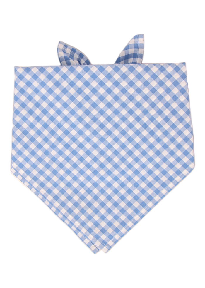 Dog bandana featuring a classic periwinkle and white plaid pattern in a diagonal grid layout. The fabric is neatly folded into a triangle and tied at the top, with the lower tip forming a sharp V-point, suitable for both small and large breeds.