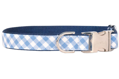 Dog collar with a classic periwinkle and white plaid pattern, layered over durable navy blue webbing. The design includes reinforced stitching, a polished silver clasp, and a metal D-ring for secure leash connection, blending charm with everyday functionality.