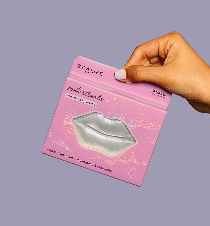 Hand holding a pink package of Spalife lip masks against a gray background