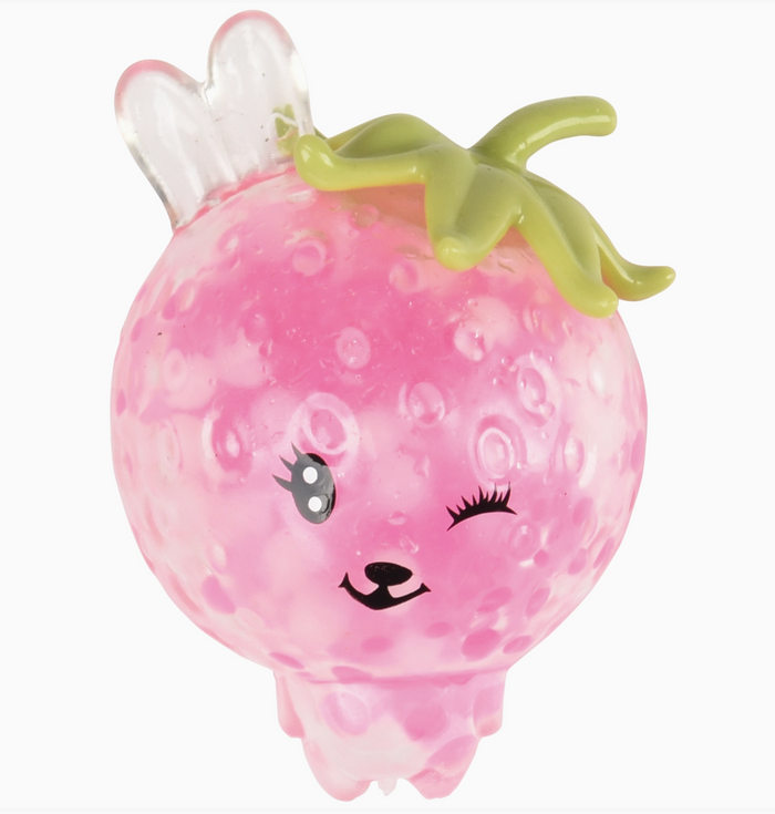 Pink grapefruit-shaped toy with a face on a white background
