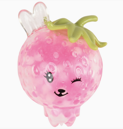 Pink grapefruit-shaped toy with a face on a white background
