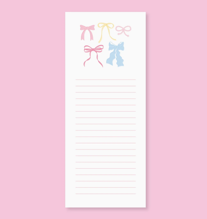 Notepad with colorful bow designs on a pink background