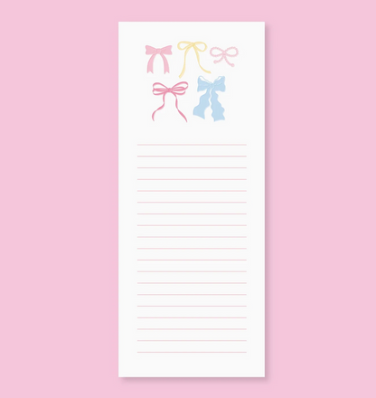 Notepad with colorful bow designs on a pink background