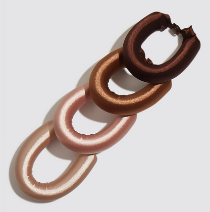 Pair of brown and pink hoop earrings on a light gray background