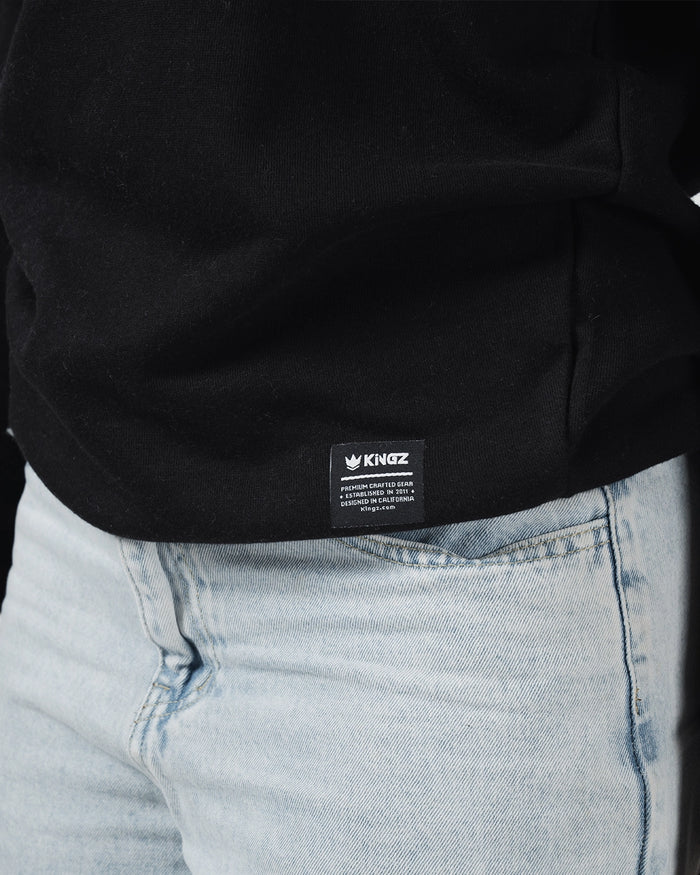 Kingz Script Quarter Zip Sweater Black - Close-Up Detail View Black Fabric Kingz Logo Tag Bottom Hem Light Blue Denim Contrast Casual Fit Hoodies BJJ Training Apparel [color:Black]