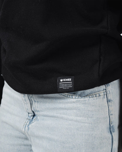 Kingz Script Quarter Zip Sweater Black - Close-Up Detail View Black Fabric Kingz Logo Tag Bottom Hem Light Blue Denim Contrast Casual Fit Hoodies BJJ Training Apparel [color:Black]