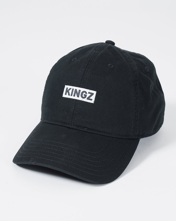Kingz Slant Dad Hat Black - Angled Front View Black Hat White KINGZ Text Front Panel Curved Brim Casual Fit BJJ Training Apparel [color:Black]