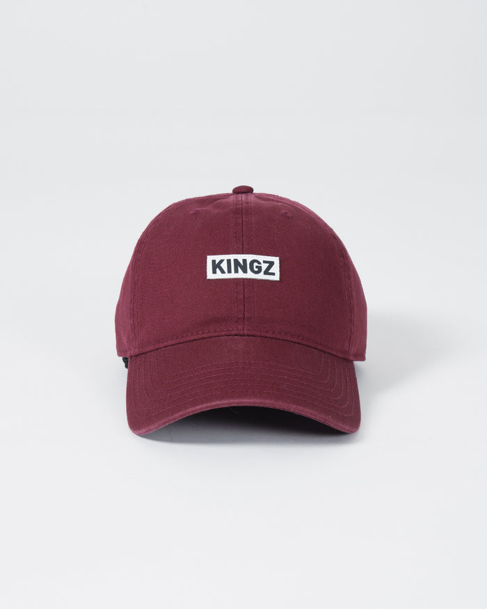 Kingz Slant Dad Hat - Maroon - Front View Maroon Hat KINGZ Text Centered Front Panel Curved Brim Casual Fit BJJ Training Apparel [color:Maroon]