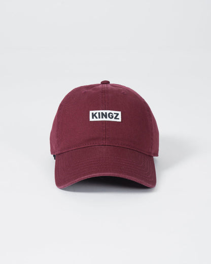 Kingz Slant Dad Hat - Maroon - Front View Maroon Hat KINGZ Text Centered Front Panel Curved Brim Casual Fit BJJ Training Apparel [color:Maroon]