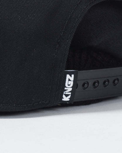 Kingz Slice Snapback Black - Close-Up Detail View Black Fabric KINGZ White Text Tag Adjustable Snap Closure BJJ Training Hat [color:Black]