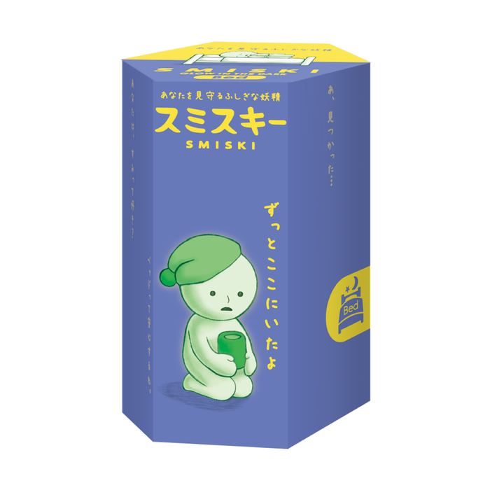 A box of a cartoon character from the SMISKI Bed Series, hiding in a bathroom corner, glowing mysteriously at night.