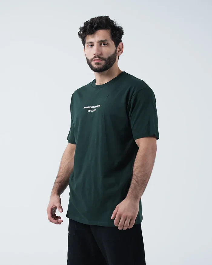 Kingz Solo Tee - Front Angle View - Kingz Kimonos Est 2011 Chest Text Side Profile - Dark Forest Green BJJ [color:Dark Forest Green]