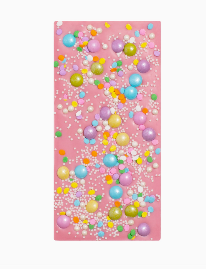 Pink towel with colorful bubble pattern on a white background
