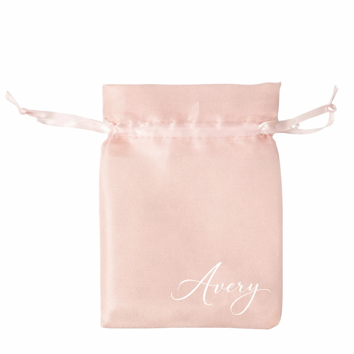 Pink satin drawstring bag with 'Avery' printed on it against a white background